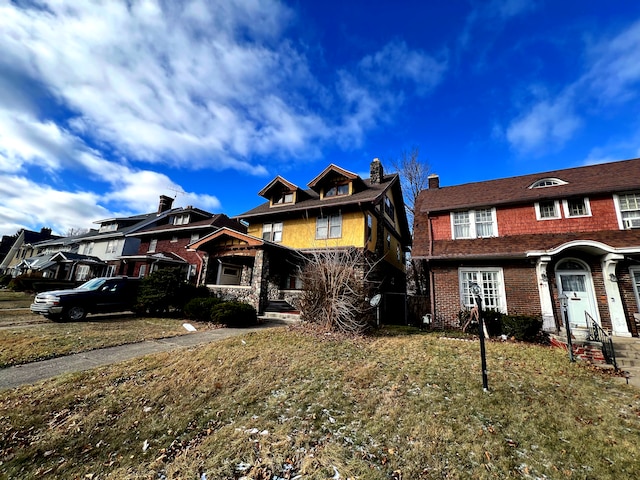 view of front of house with brick siding and a front yard