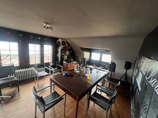 dining area featuring radiator heating unit, wood finished floors, and plenty of natural light