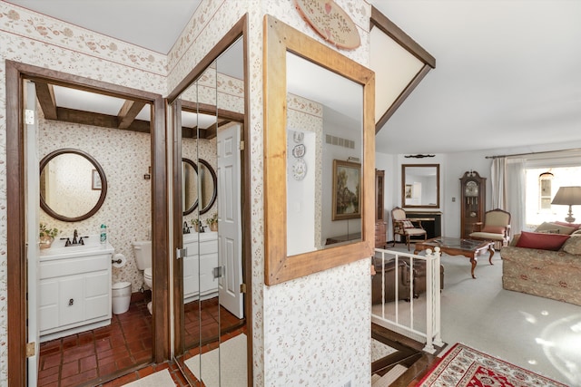 bathroom featuring vanity and toilet