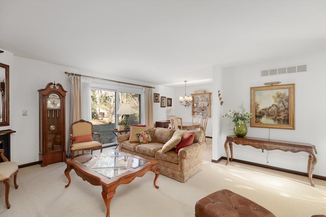 carpeted living room featuring a notable chandelier