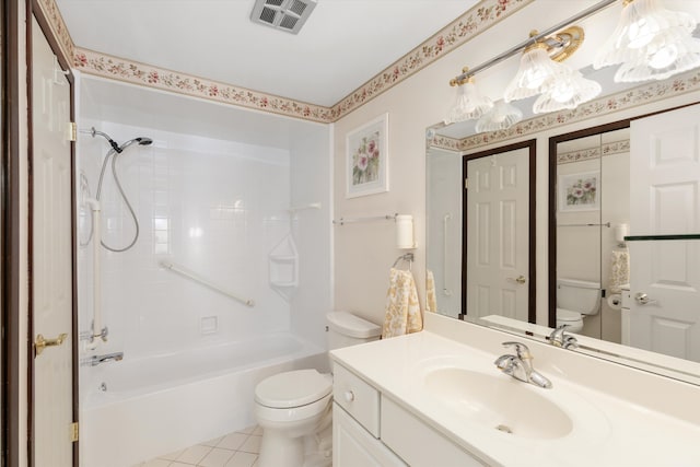 full bathroom with tile patterned flooring, tiled shower / bath combo, toilet, and vanity