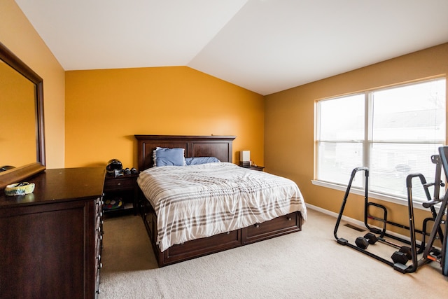 bedroom featuring light carpet and lofted ceiling