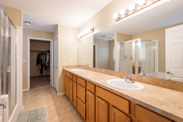 bathroom featuring vanity and a shower with door