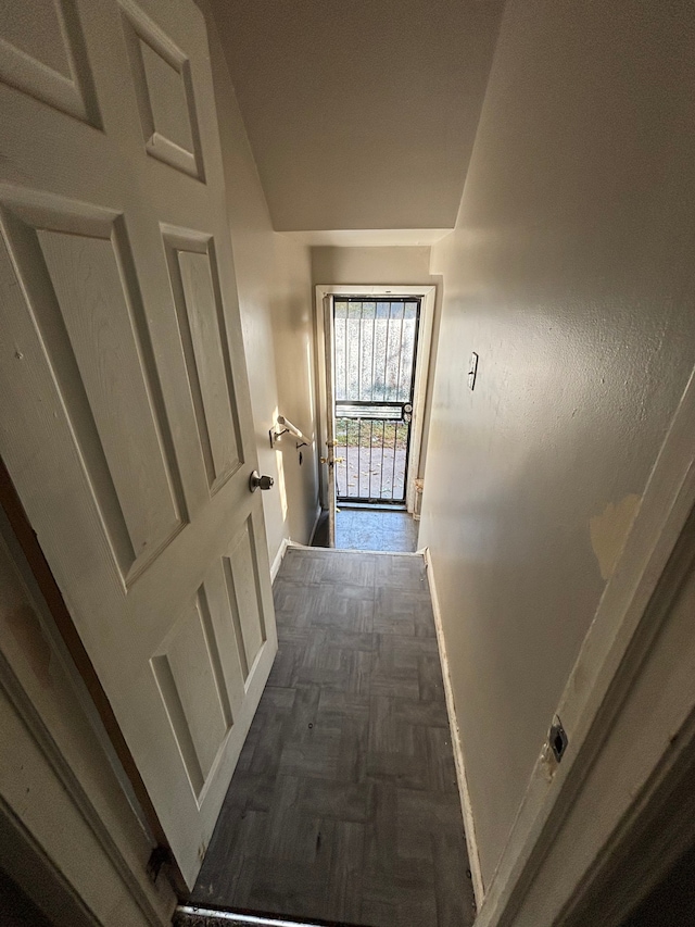 hall featuring dark parquet flooring