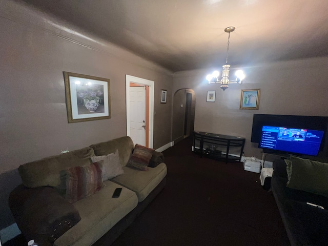 living room with dark carpet and an inviting chandelier