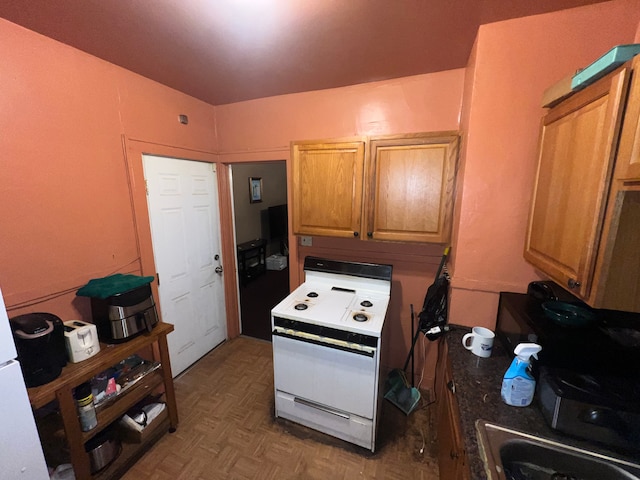 kitchen featuring electric range and dark parquet floors