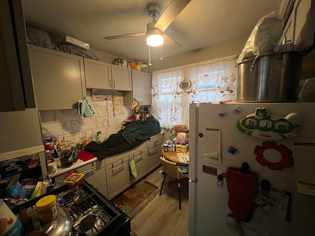 kitchen featuring ceiling fan, white refrigerator, and light hardwood / wood-style floors