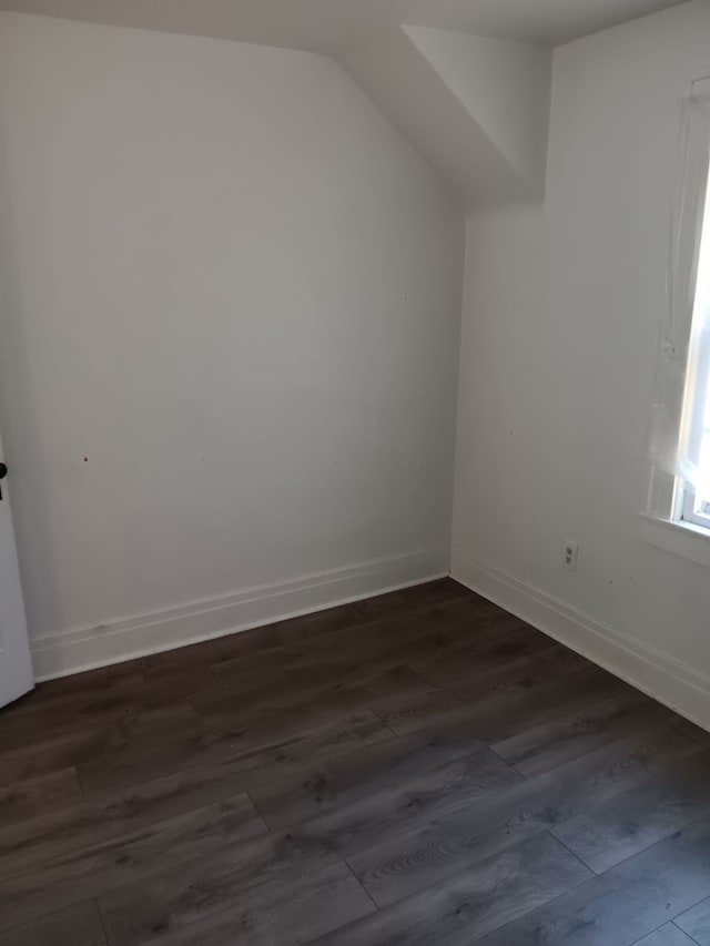 bonus room featuring vaulted ceiling and dark hardwood / wood-style floors