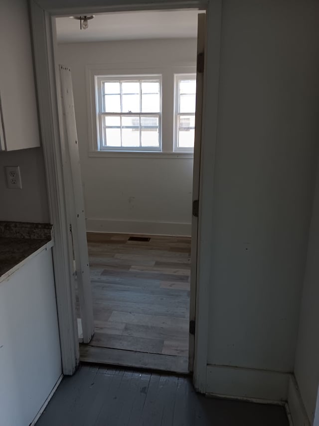 hall with dark hardwood / wood-style flooring