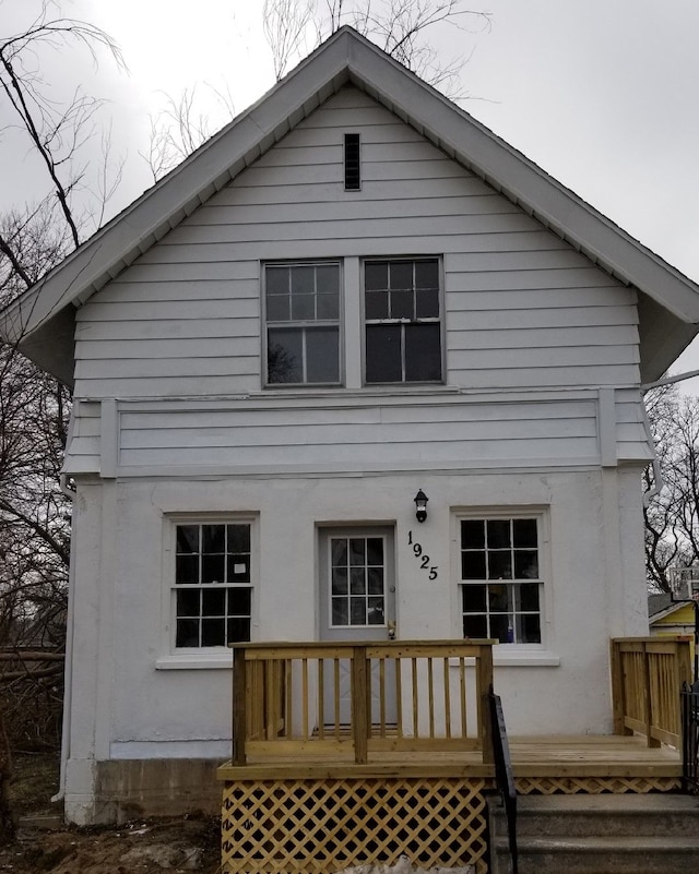 back of house featuring a wooden deck