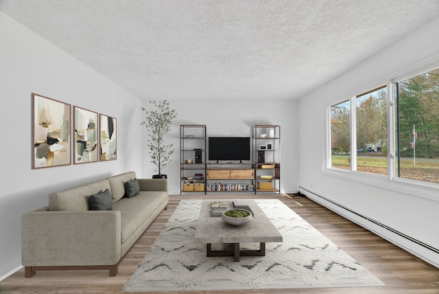 living room featuring a textured ceiling, a baseboard radiator, and hardwood / wood-style flooring