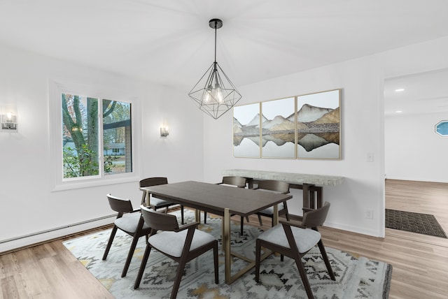 dining space with light hardwood / wood-style floors and baseboard heating