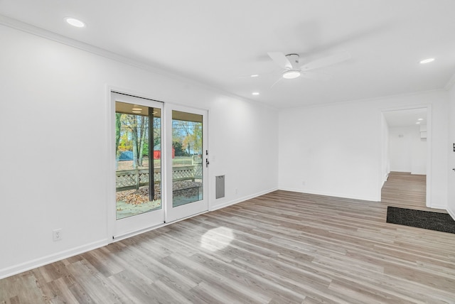 empty room with ceiling fan, light hardwood / wood-style floors, and crown molding