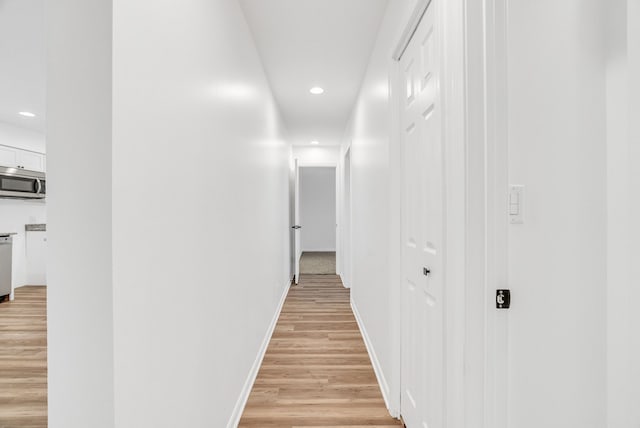 hallway with light hardwood / wood-style flooring