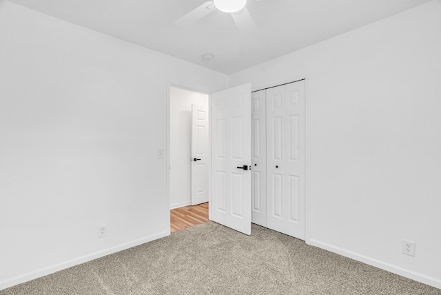 unfurnished bedroom with ceiling fan, carpet floors, and a closet