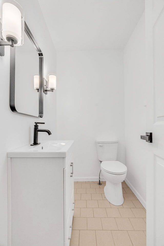 bathroom featuring tile patterned floors, vanity, and toilet