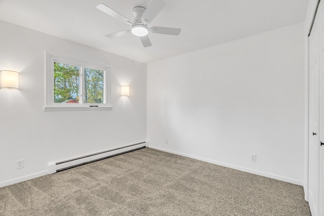 carpeted empty room featuring ceiling fan and a baseboard heating unit