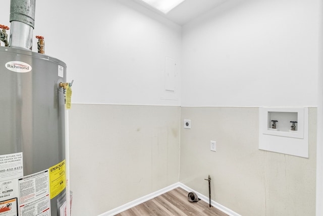 clothes washing area featuring hookup for a washing machine, wood-type flooring, gas water heater, and hookup for an electric dryer