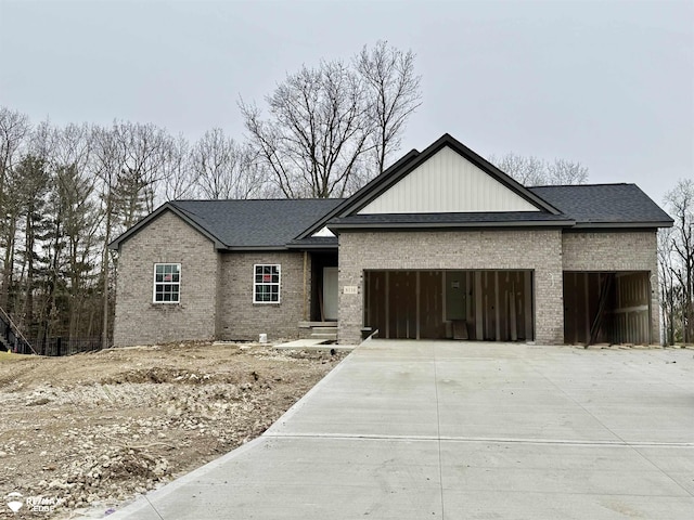 view of front of property with driveway, brick siding, and an attached garage