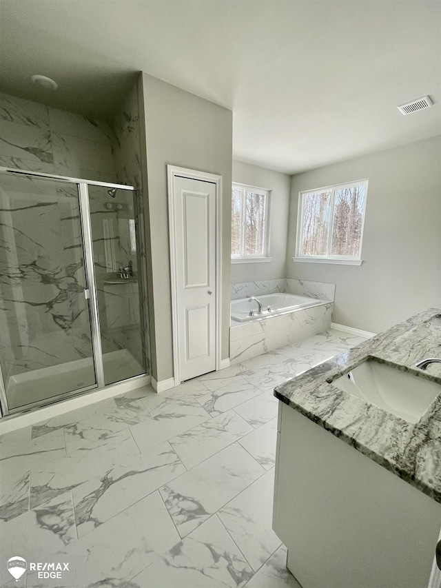 bathroom featuring vanity and separate shower and tub