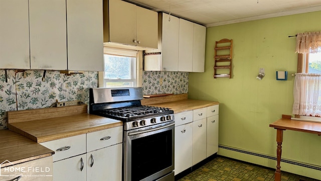 kitchen with white cabinets, plenty of natural light, stainless steel gas range oven, and a baseboard heating unit