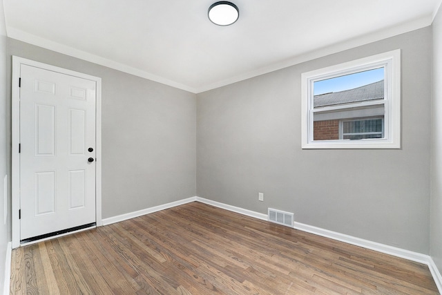 unfurnished room featuring crown molding and hardwood / wood-style flooring