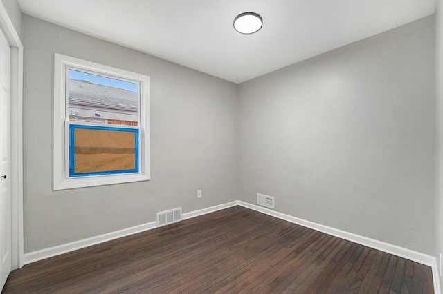 empty room with dark wood-type flooring