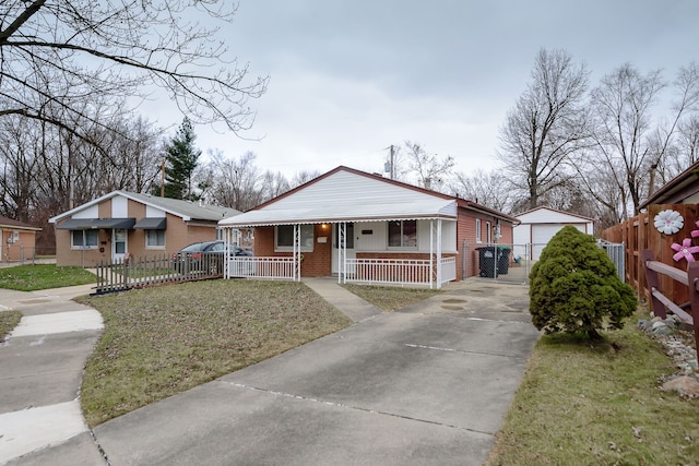 view of front facade featuring covered porch, an outbuilding, a garage, and a front yard