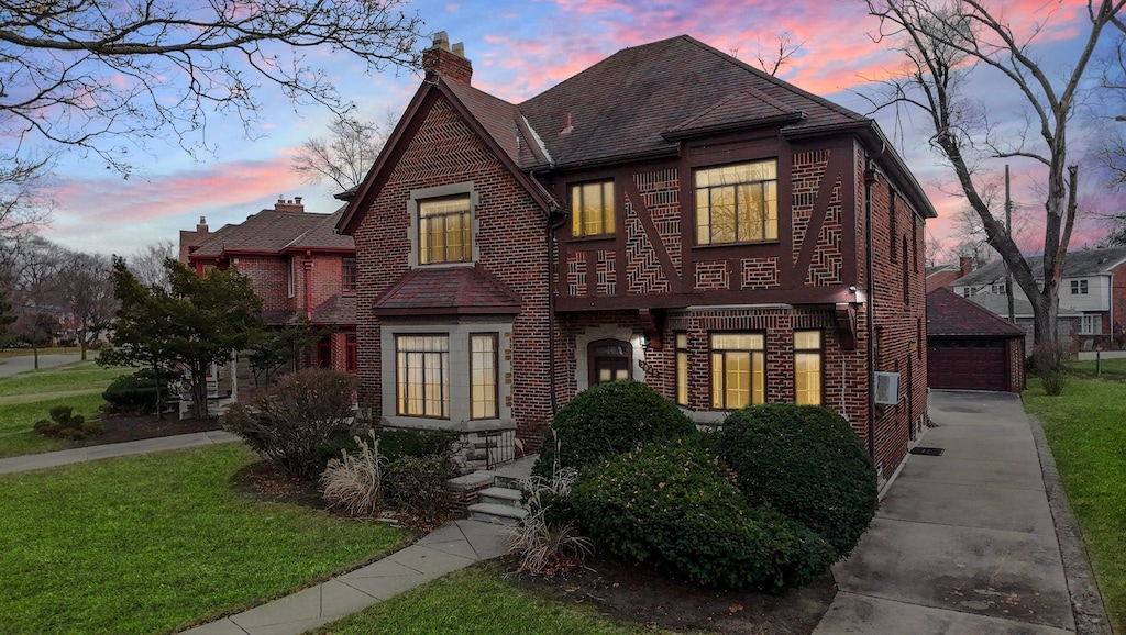 tudor-style house featuring a yard