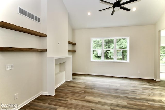 unfurnished living room featuring a ceiling fan, plenty of natural light, wood finished floors, baseboards, and high vaulted ceiling