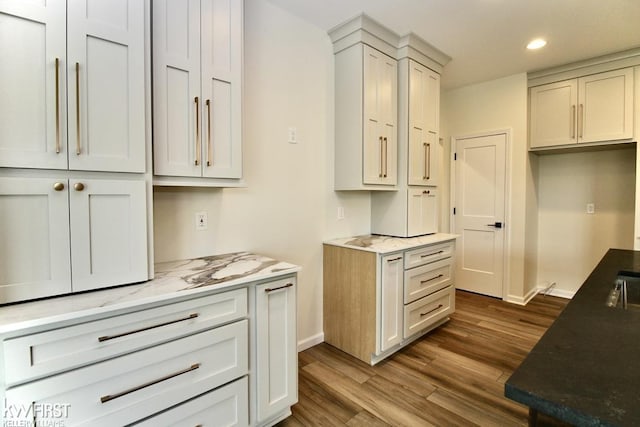 kitchen featuring dark wood finished floors, baseboards, and recessed lighting
