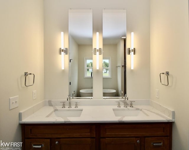 full bathroom with toilet and double vanity
