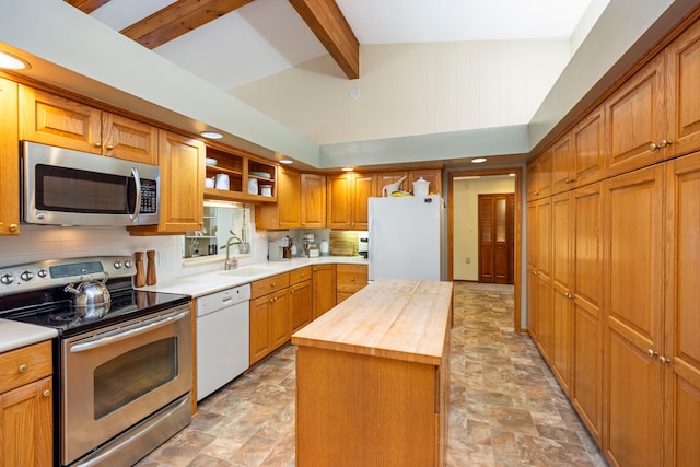 kitchen with beam ceiling, sink, a center island, stainless steel appliances, and butcher block countertops