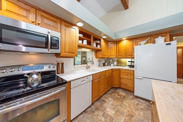 kitchen featuring vaulted ceiling with beams, stainless steel appliances, tasteful backsplash, and sink