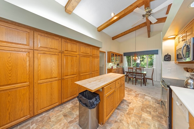 kitchen with tasteful backsplash, beam ceiling, stainless steel appliances, and hanging light fixtures