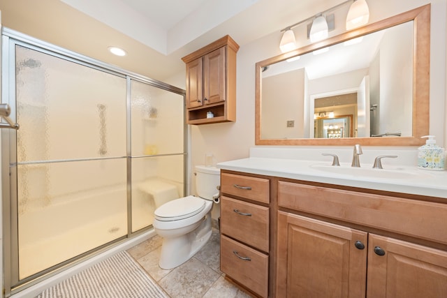 bathroom featuring vanity, an enclosed shower, and toilet