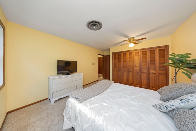 bedroom featuring light colored carpet and ceiling fan