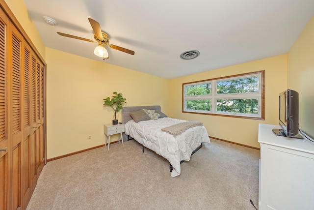 carpeted bedroom with a closet and ceiling fan