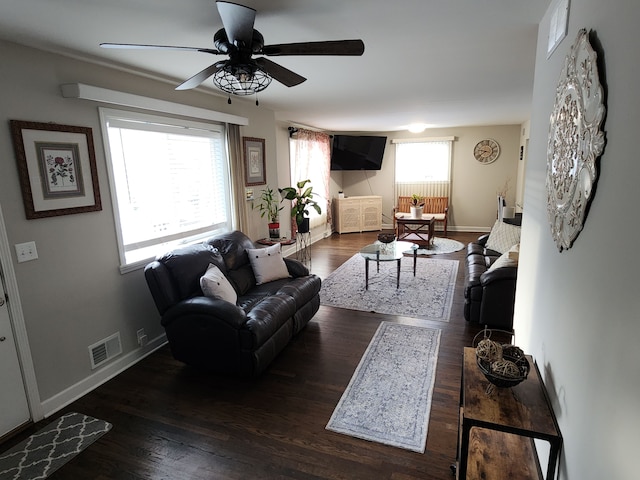 living room with ceiling fan and dark hardwood / wood-style flooring