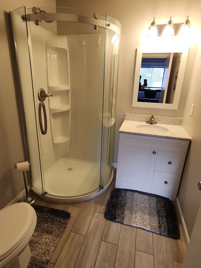 bathroom with vanity, toilet, and walk in shower