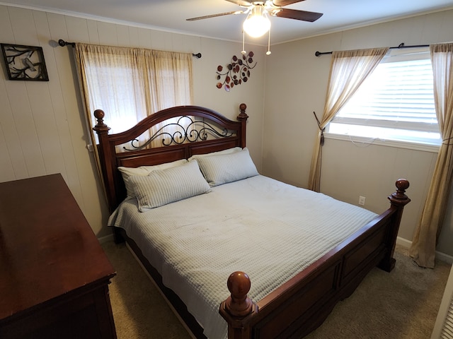 bedroom featuring dark carpet, ceiling fan, and ornamental molding