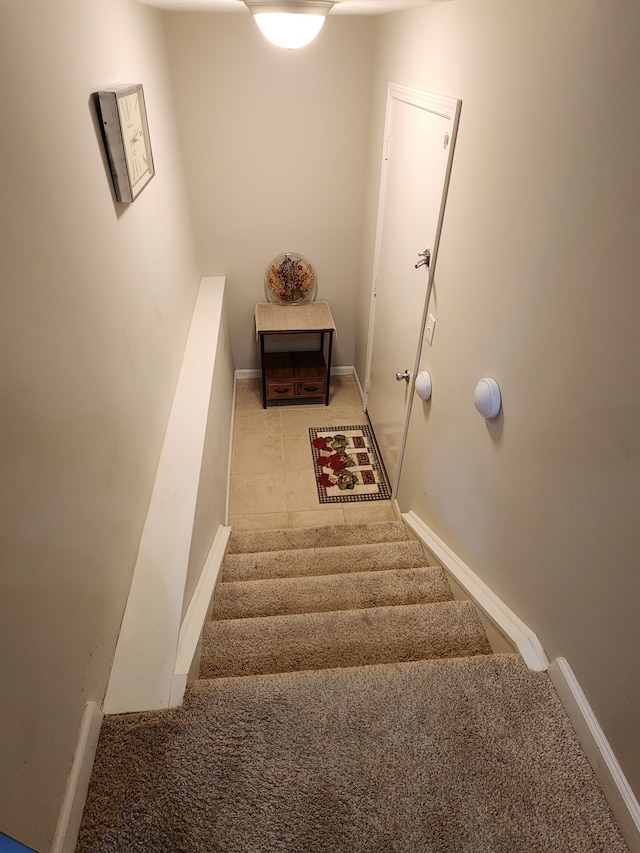 stairway with tile patterned flooring