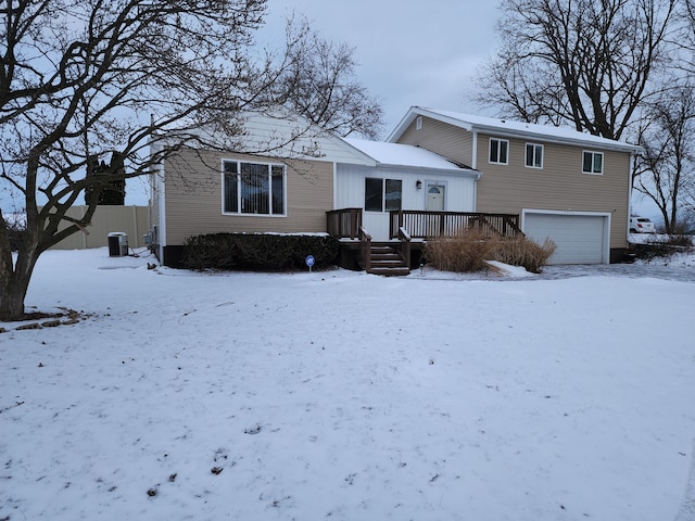 view of front facade featuring central AC unit, a garage, and a wooden deck