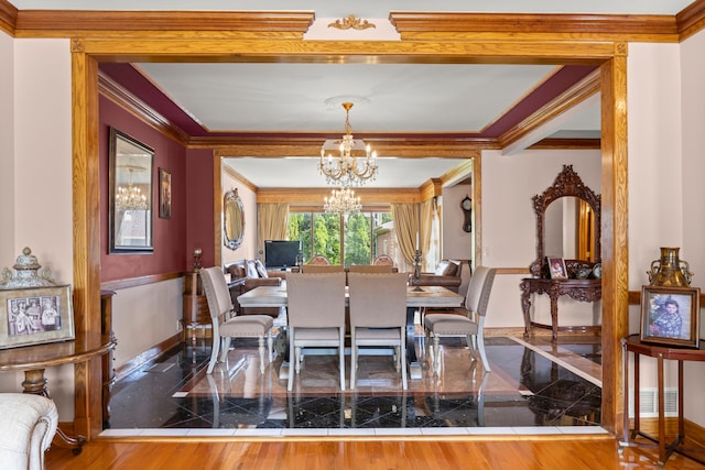 dining area featuring a notable chandelier and ornamental molding