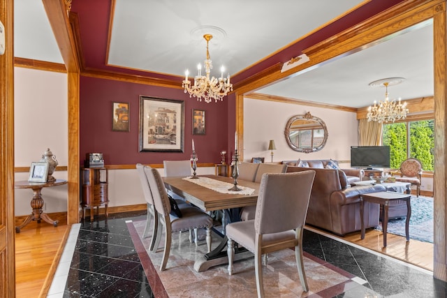 dining space featuring a notable chandelier and crown molding