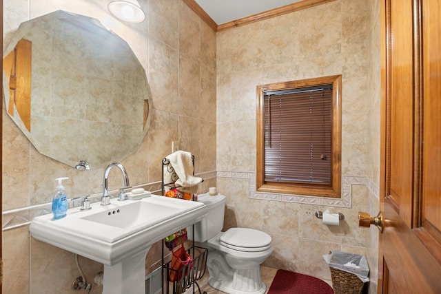 bathroom featuring toilet, tile walls, crown molding, and sink