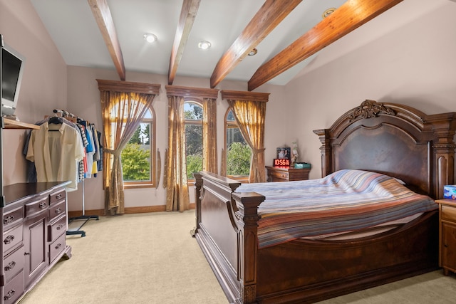 carpeted bedroom featuring beamed ceiling