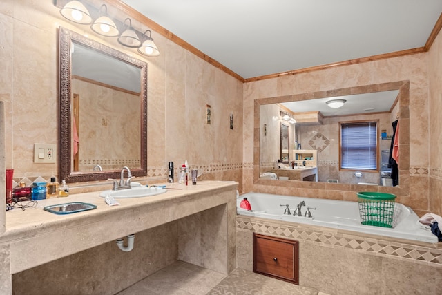 bathroom with tile patterned floors, tiled tub, crown molding, and sink