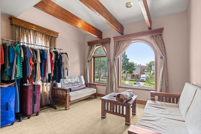 bedroom with beamed ceiling and carpet floors