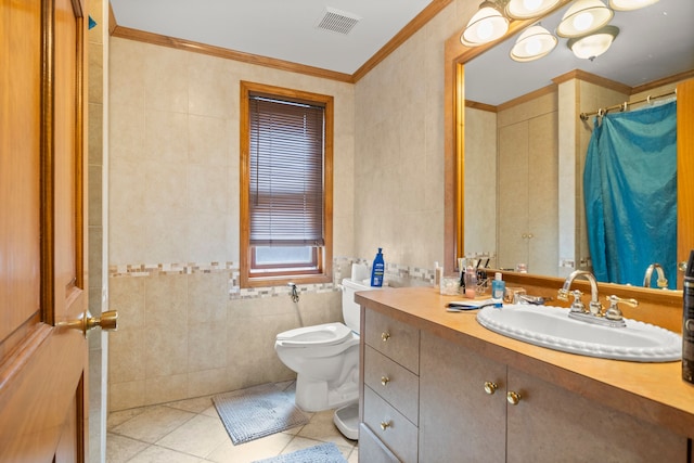 bathroom featuring vanity, tile patterned flooring, toilet, ornamental molding, and tile walls